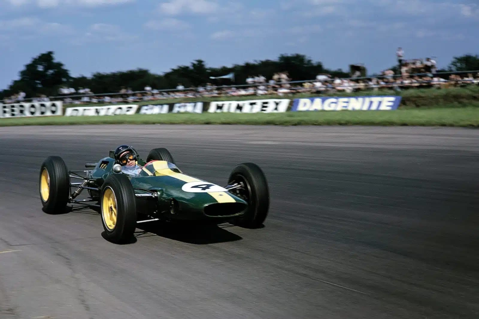 The Lotus 25 going around a corner in a 1960s Formula 1 race